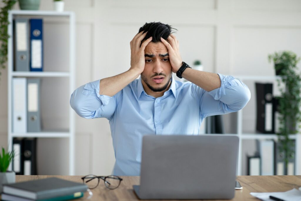 Desperate Arab businessman having too much work, making mistake, cannot meet deadline, suffering